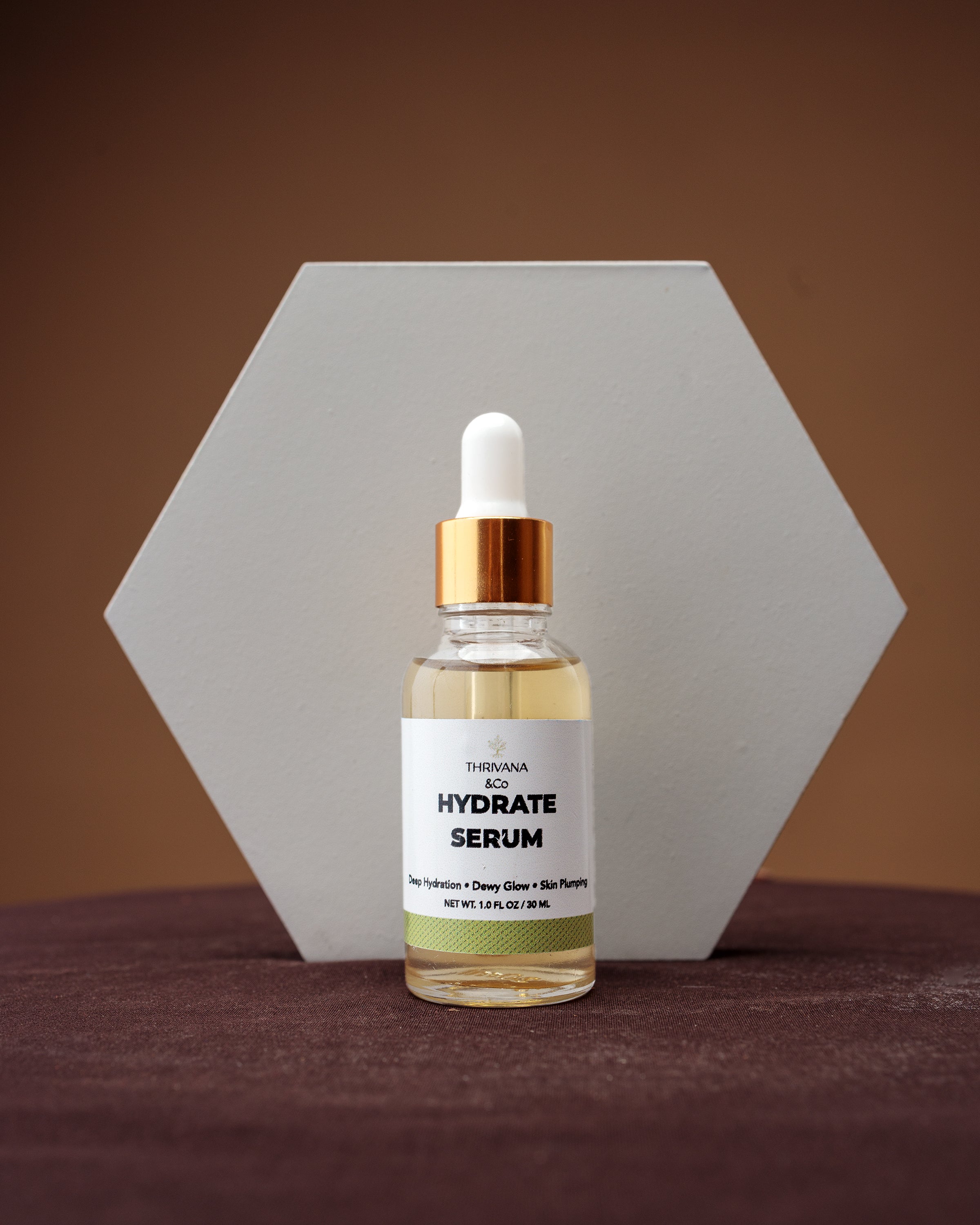 Hydrate serum bottle with dropper on a brown background